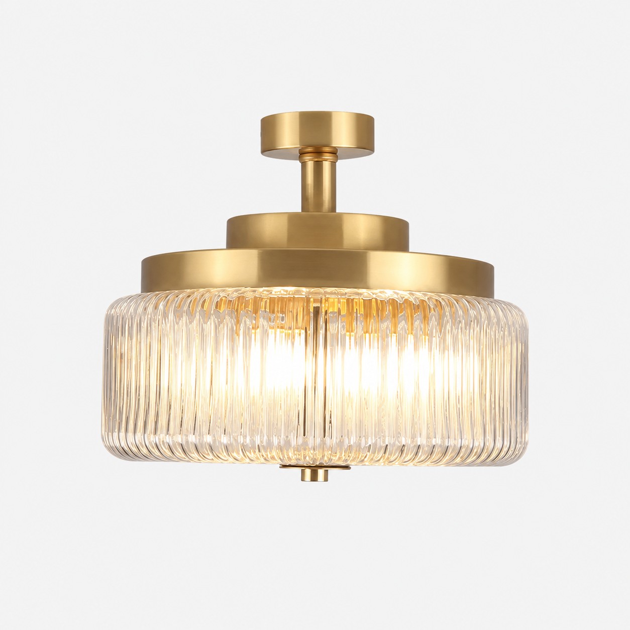 Antique brass ceiling light with ribbed glass shade on a clean background