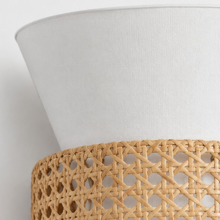White fabric shade rim meeting the natural rattan weave
