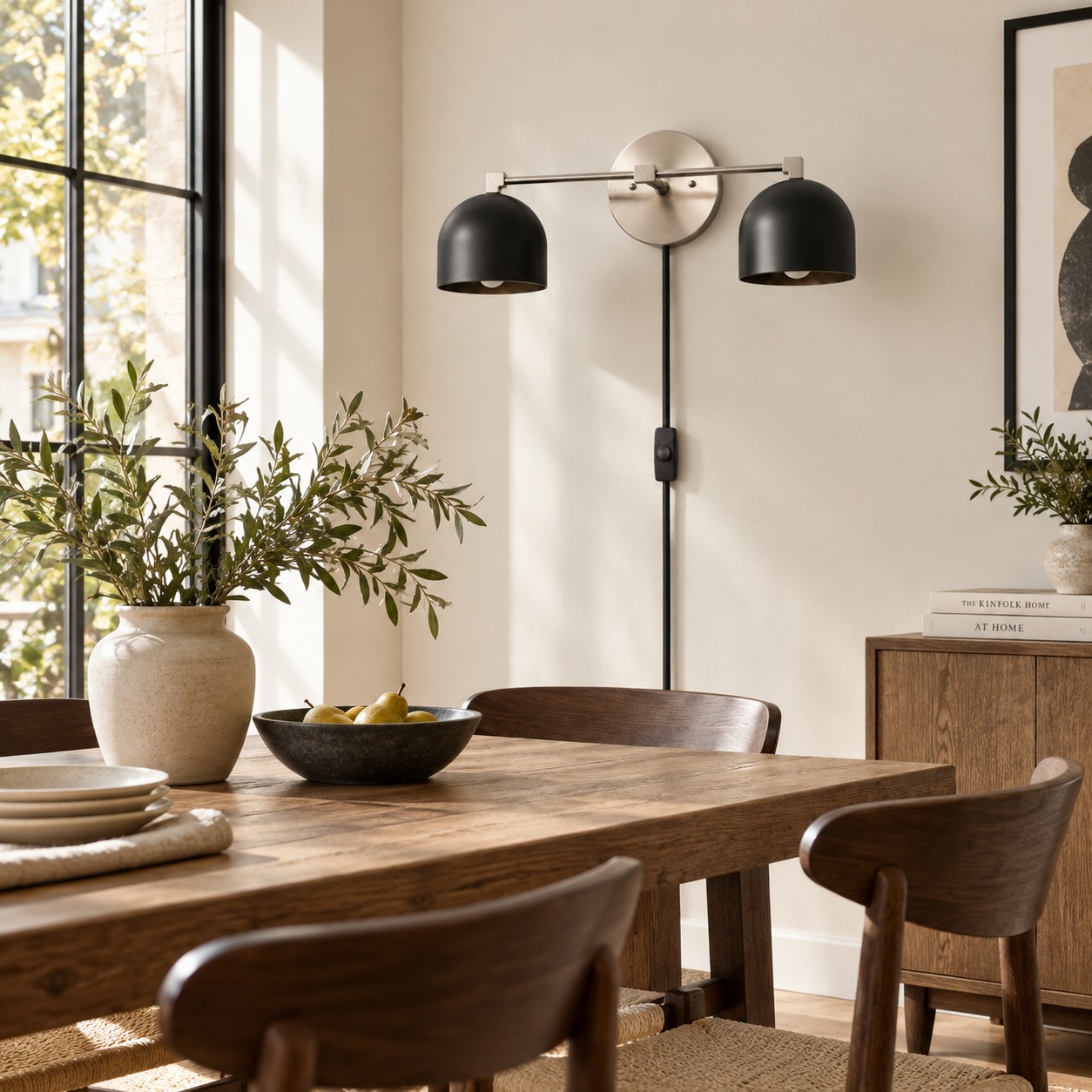 Black dome wall lamp mounted on the dining-room wall beside the table