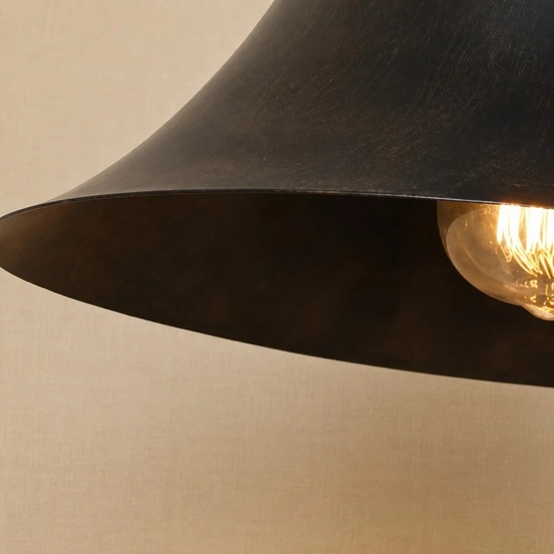 Close view of the flared shade and warm bulb glow