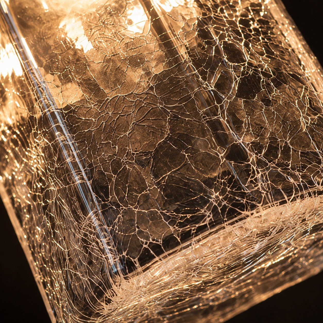 Crackle glass pendant illuminated from within
