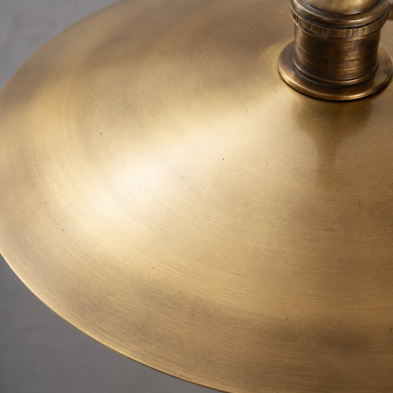 Close view of the Cantina wall lamp shade and socket in antique brass