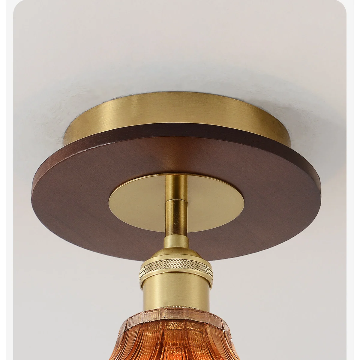 Brown ceiling plate and warm metal fitting detail