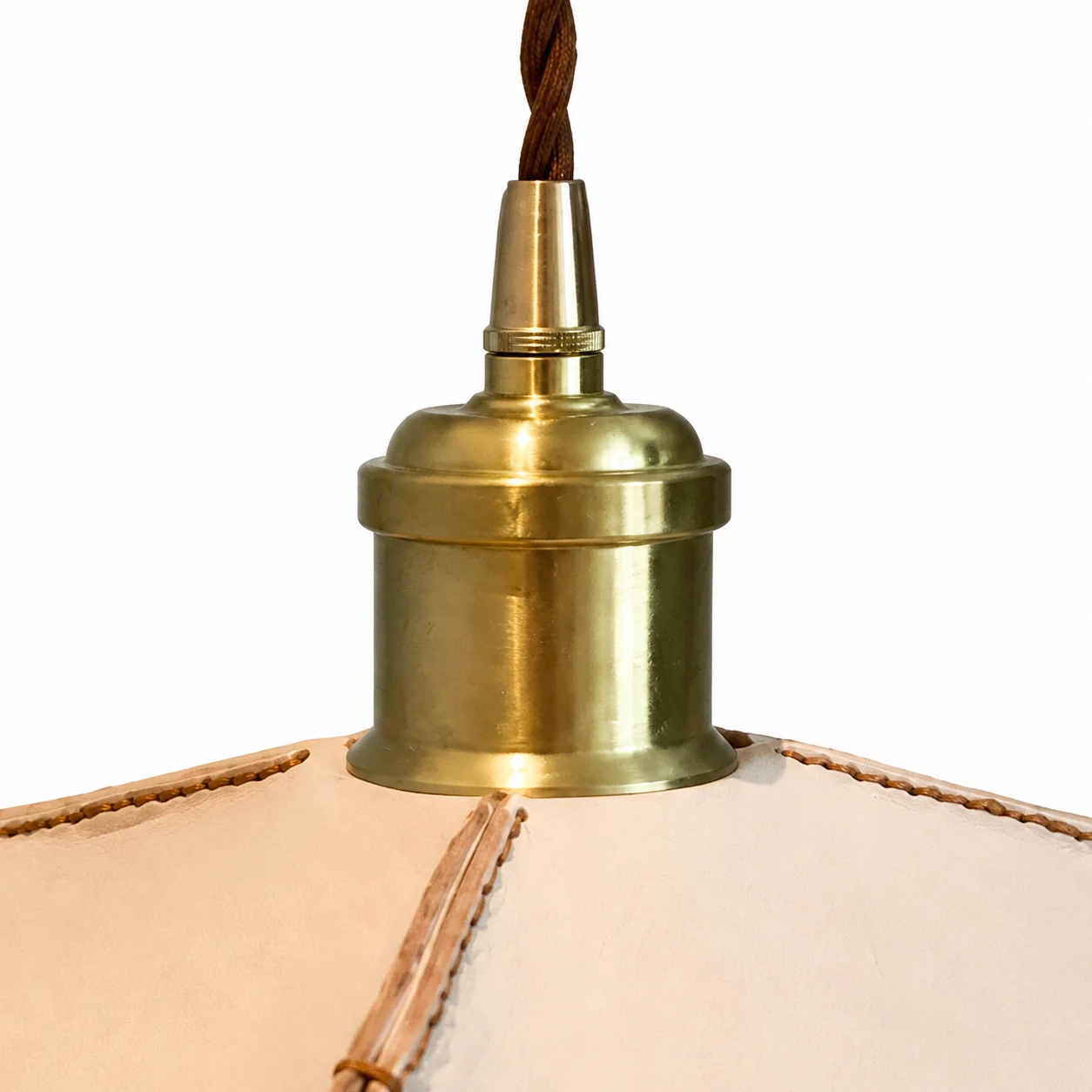 Close-up of brass-tone metal pendant socket and leather shade top