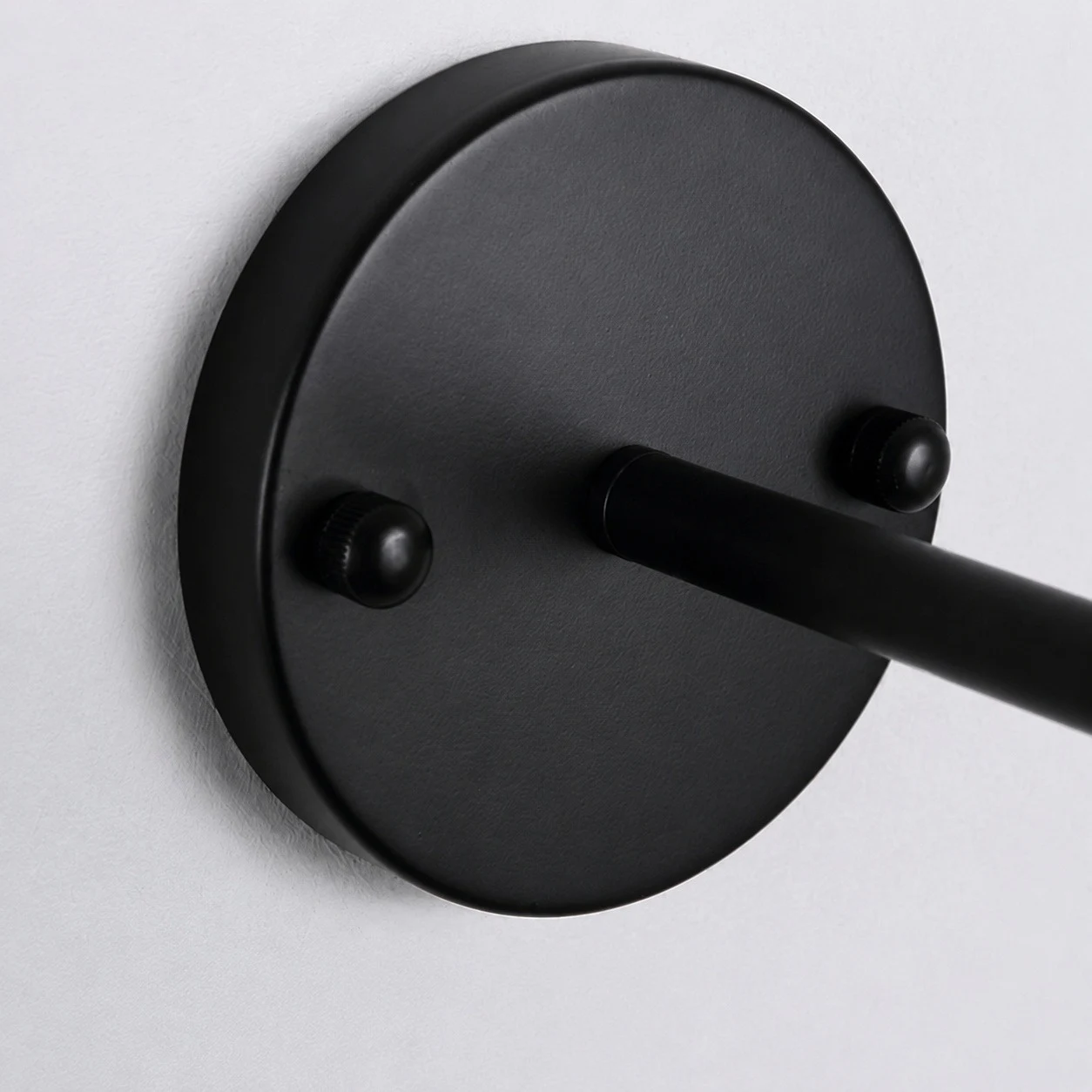 Round black canopy mounted to the wall
