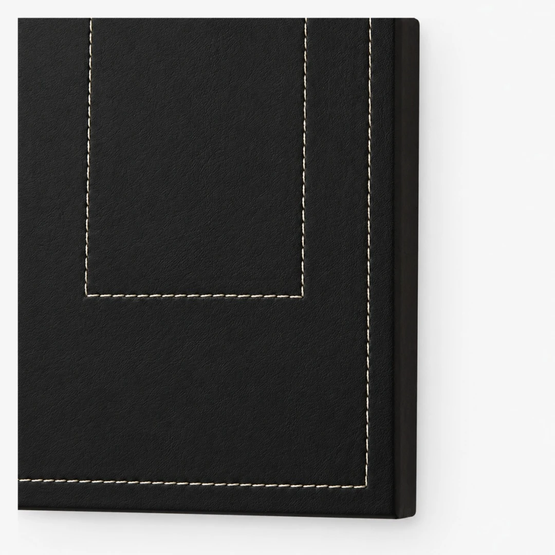 Close view of dark leather panel and contrast stitching