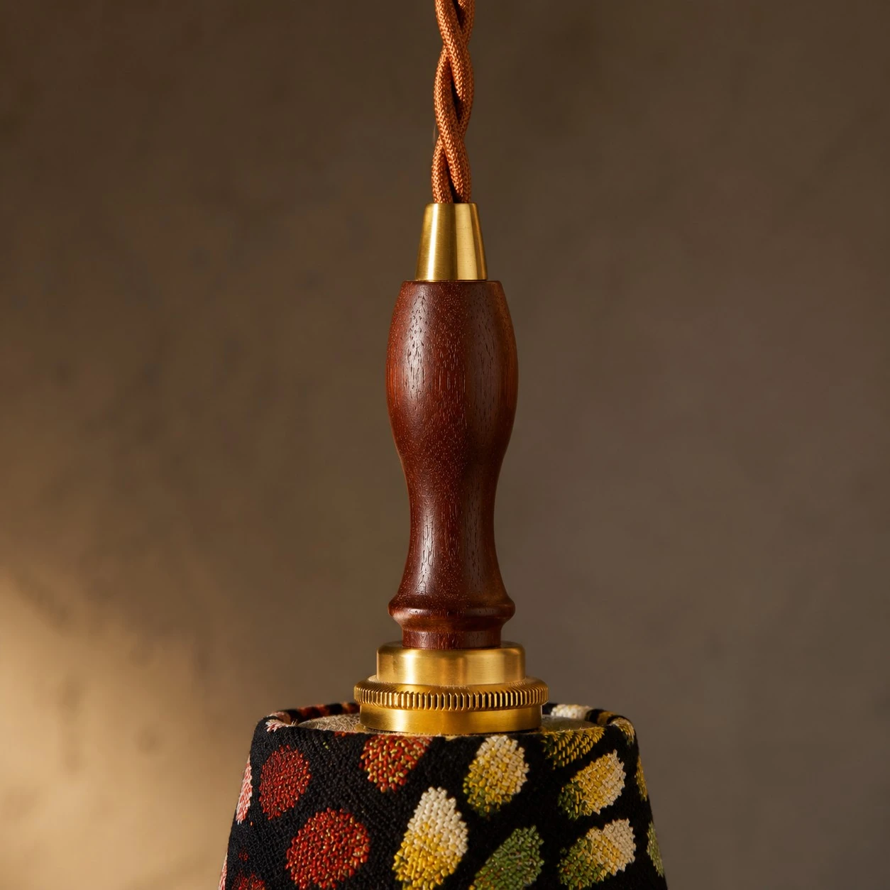 Close view of the wood handle and braided cord