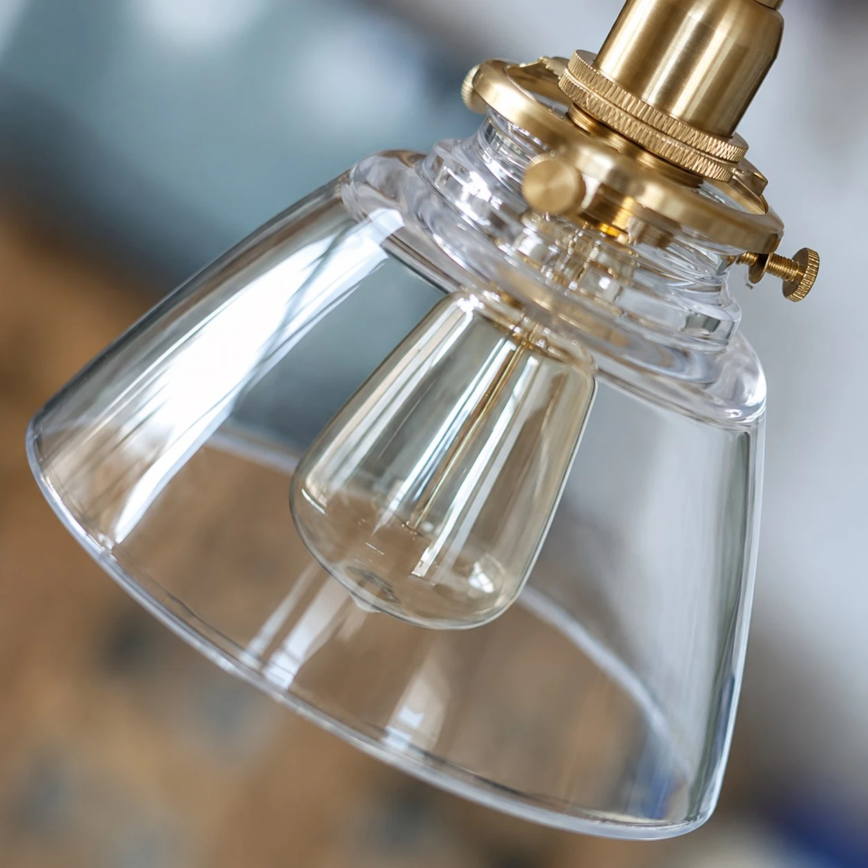 Clear glass shade and brass lamp holder detail