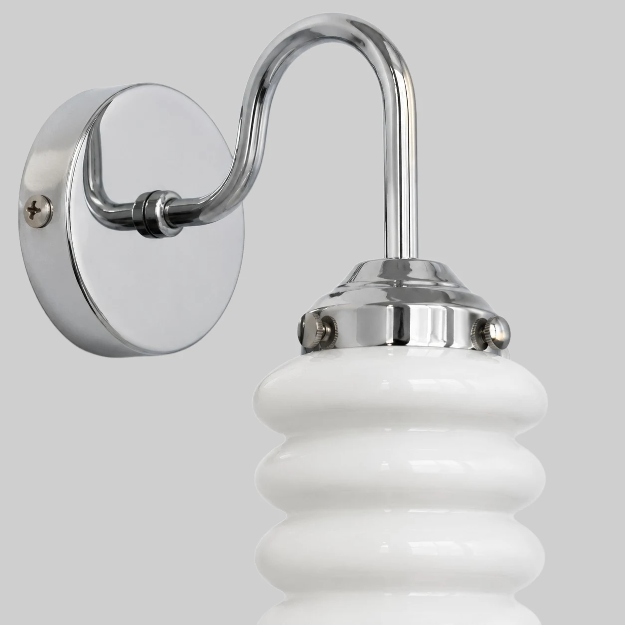 Chrome wall plate and white ribbed shade close view
