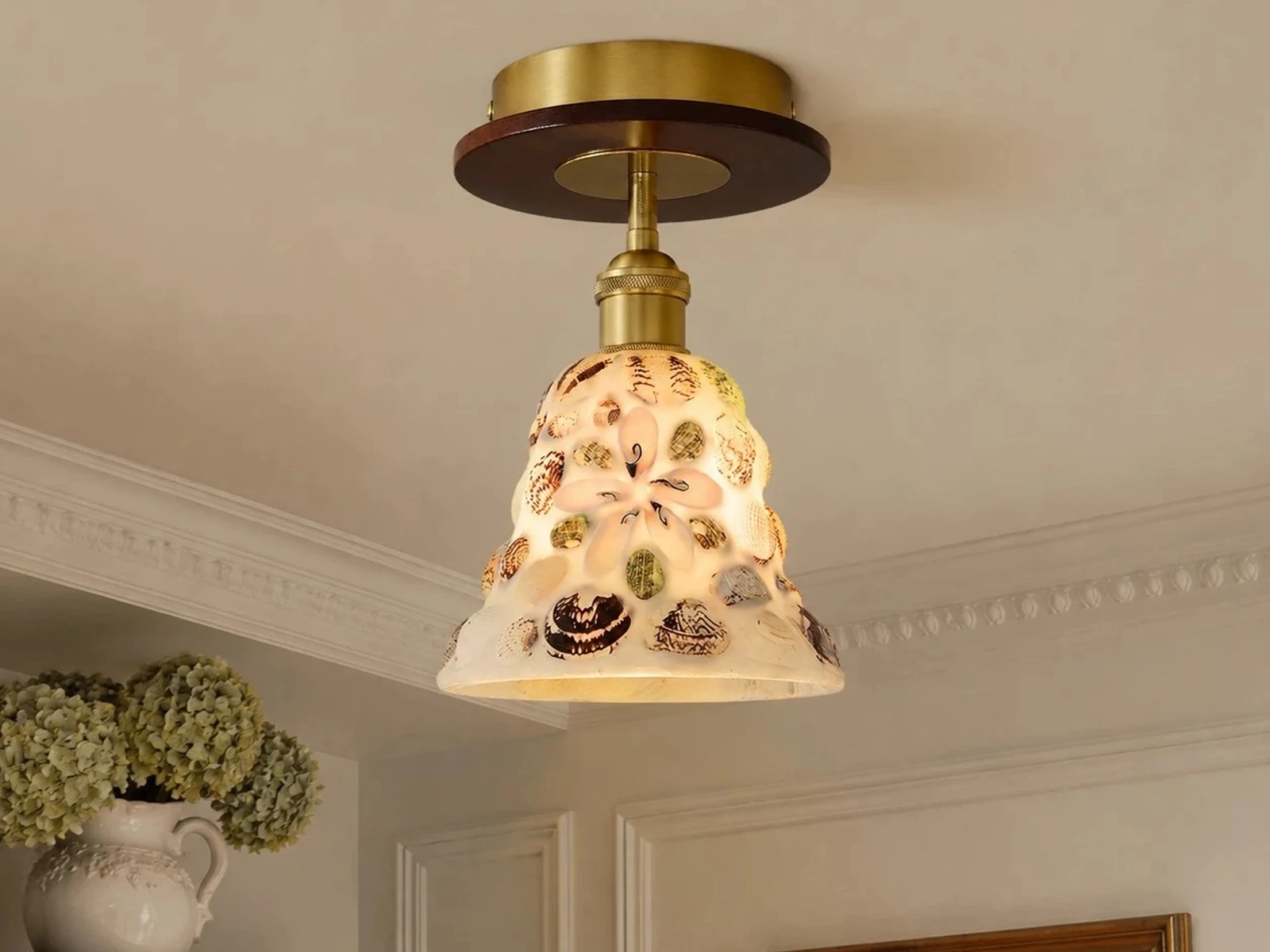 Shell glass flush mount ceiling light installed in a hallway