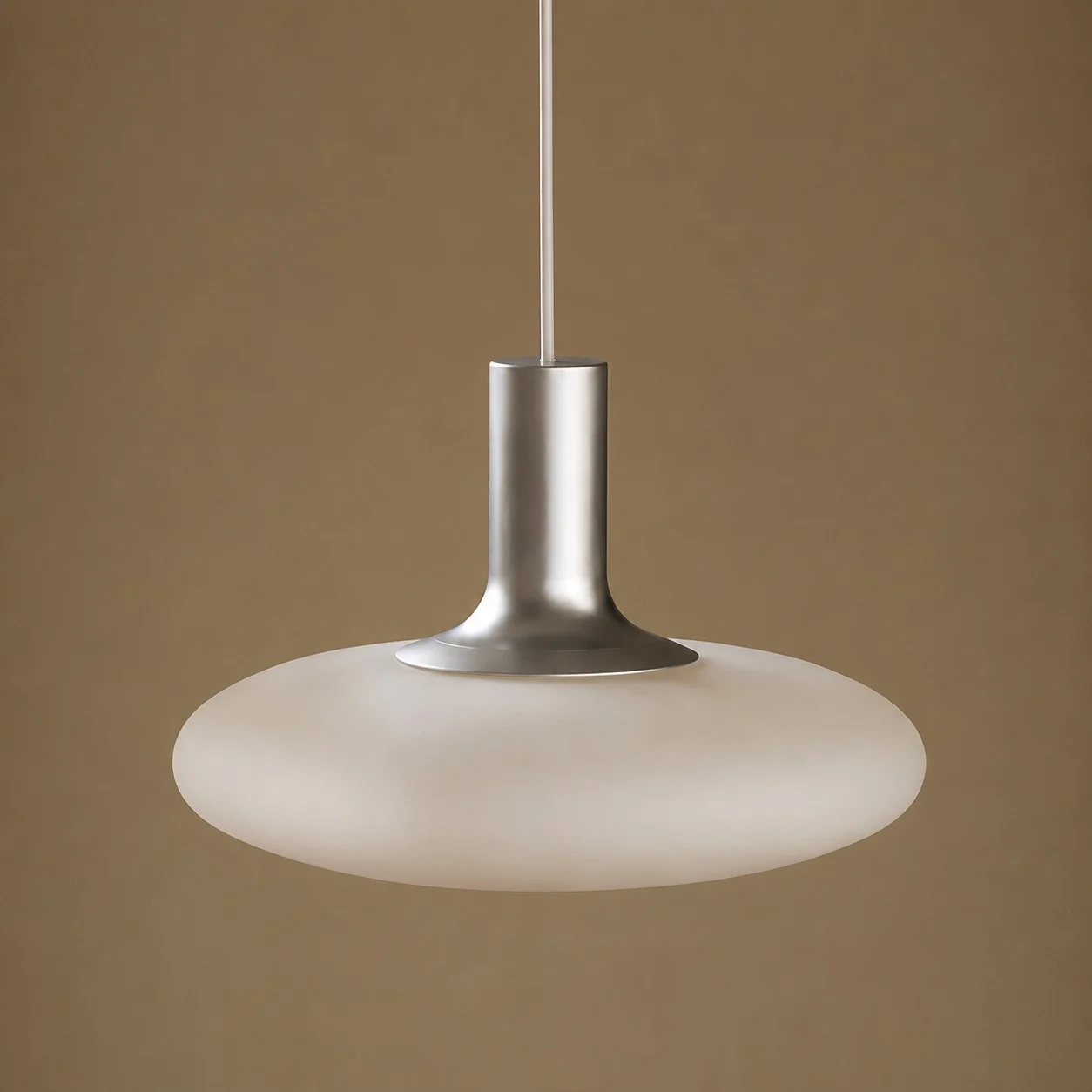 Close view of white glass shade and chrome metal pendant neck