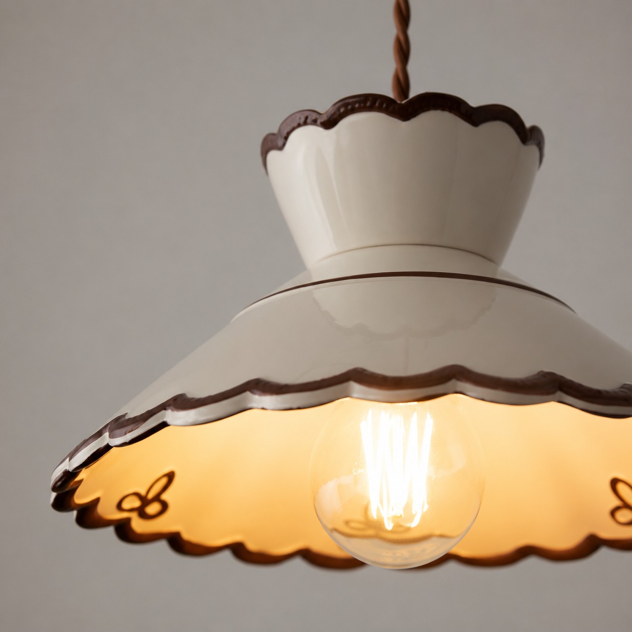 Close detail of creamy white scalloped ceramic pendant shade