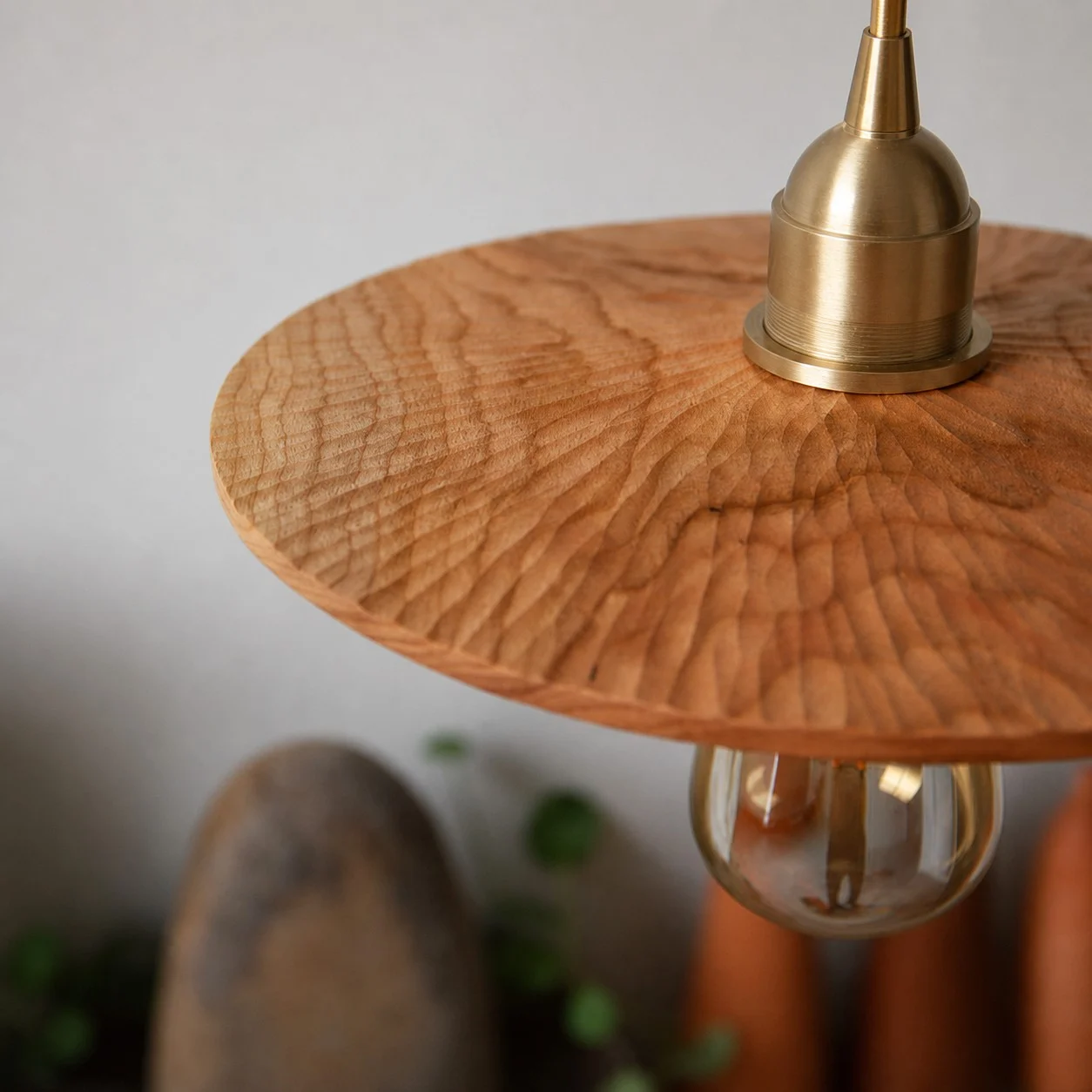Close detail of carved cherry wood texture and brass lamp holder