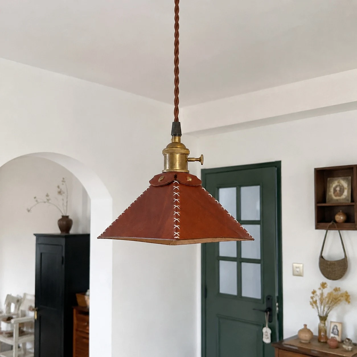 Leather pyramid pendant lamp in arched room