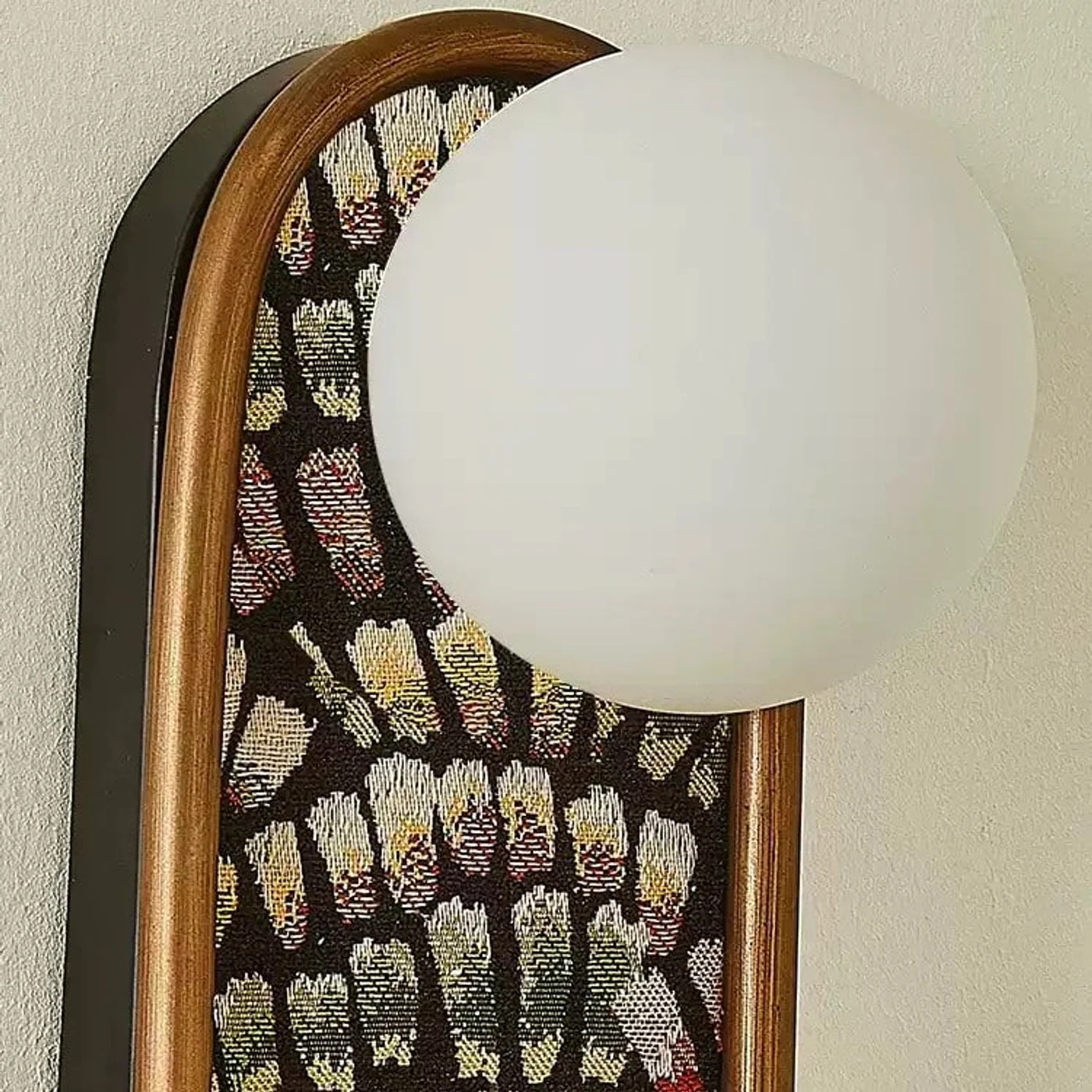 Globe shade and patterned fabric wall sconce detail