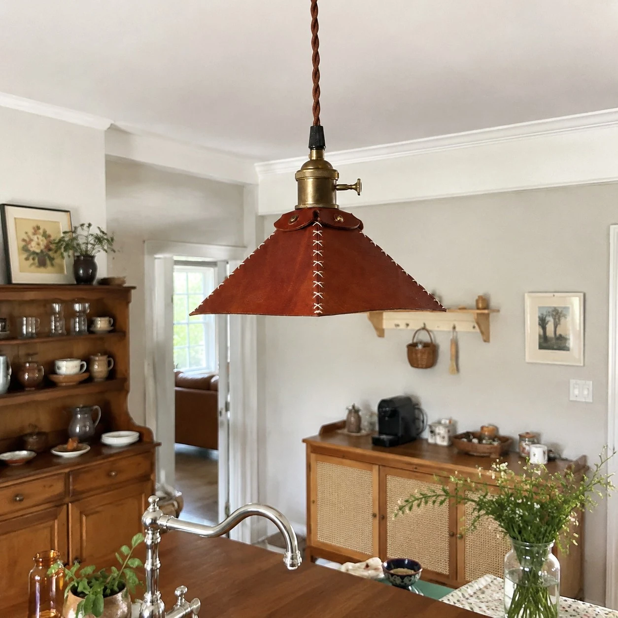 Leather pendant lamp above kitchen dining counter