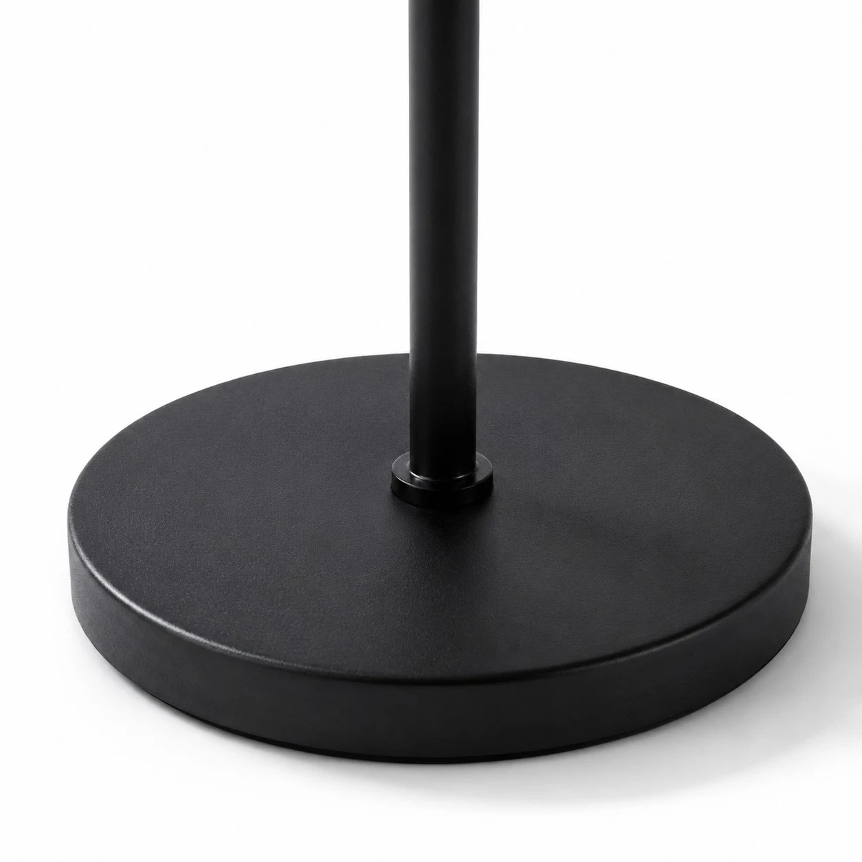 Close view of round black floor lamp base