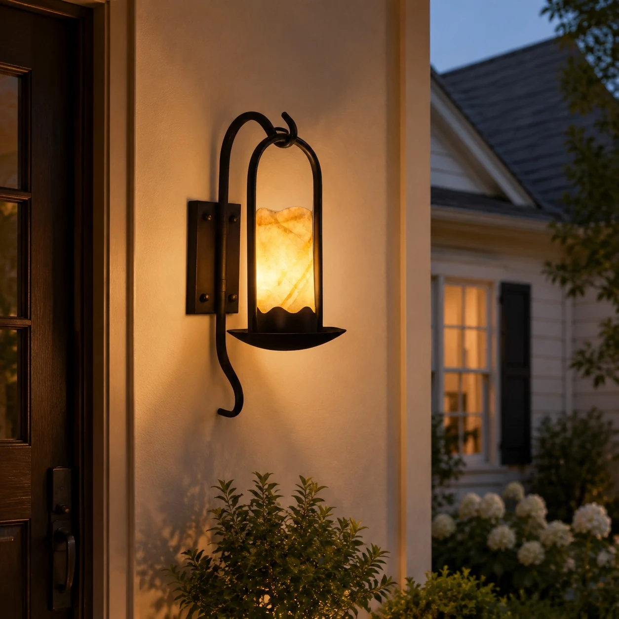 Black marble glass wall sconce installed near an exterior doorway