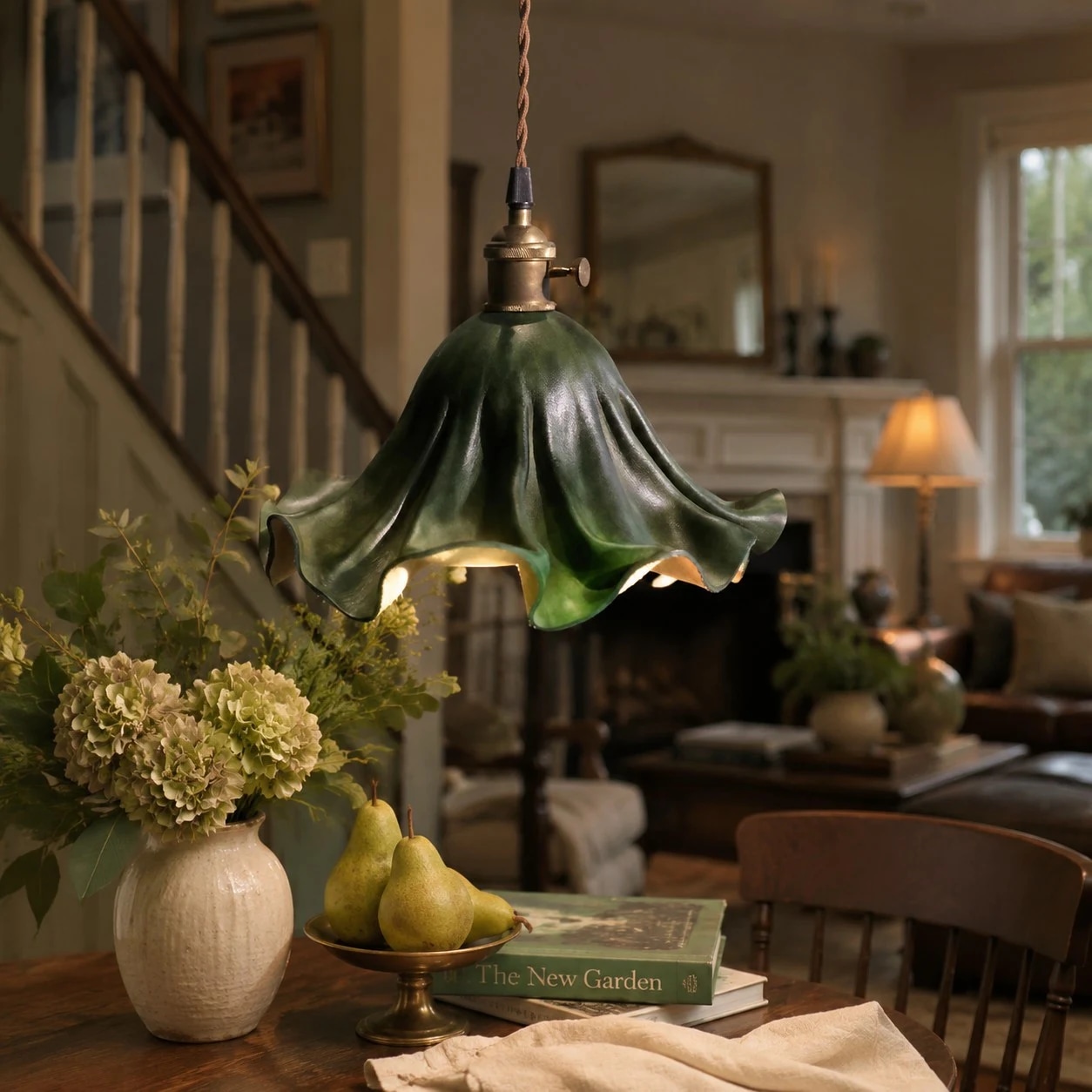 Dark green pleated leather pendant light in a warm dining room