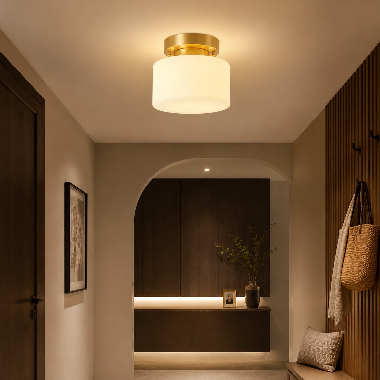 Low-profile brass ceiling light illuminating a corridor