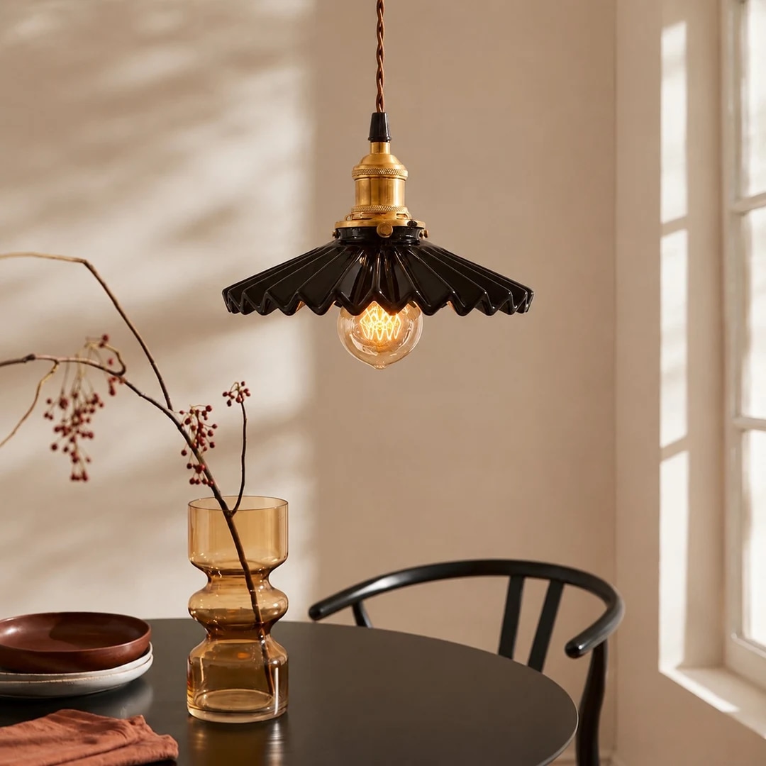 Pleated ceramic pendant light above a dining table
