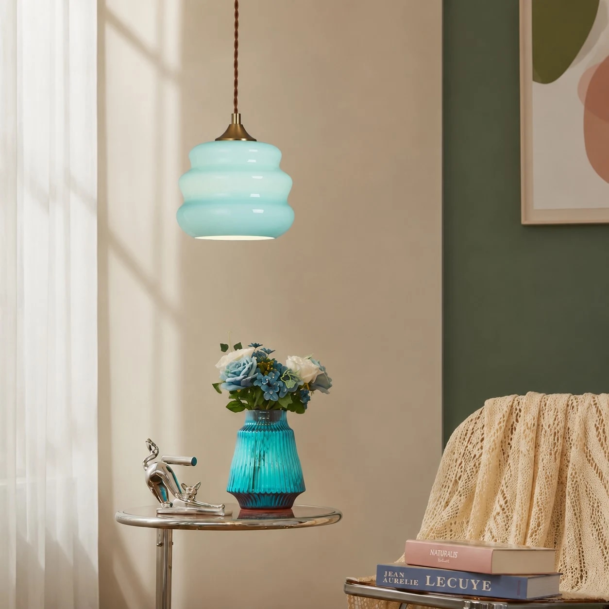 Pendant light beside books and flowers