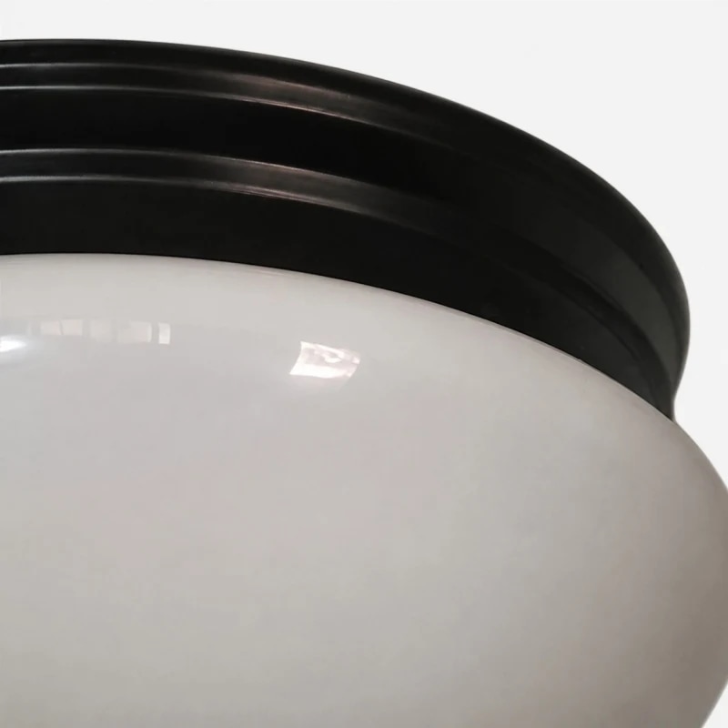 Close detail of opal glass shade and black canopy rim