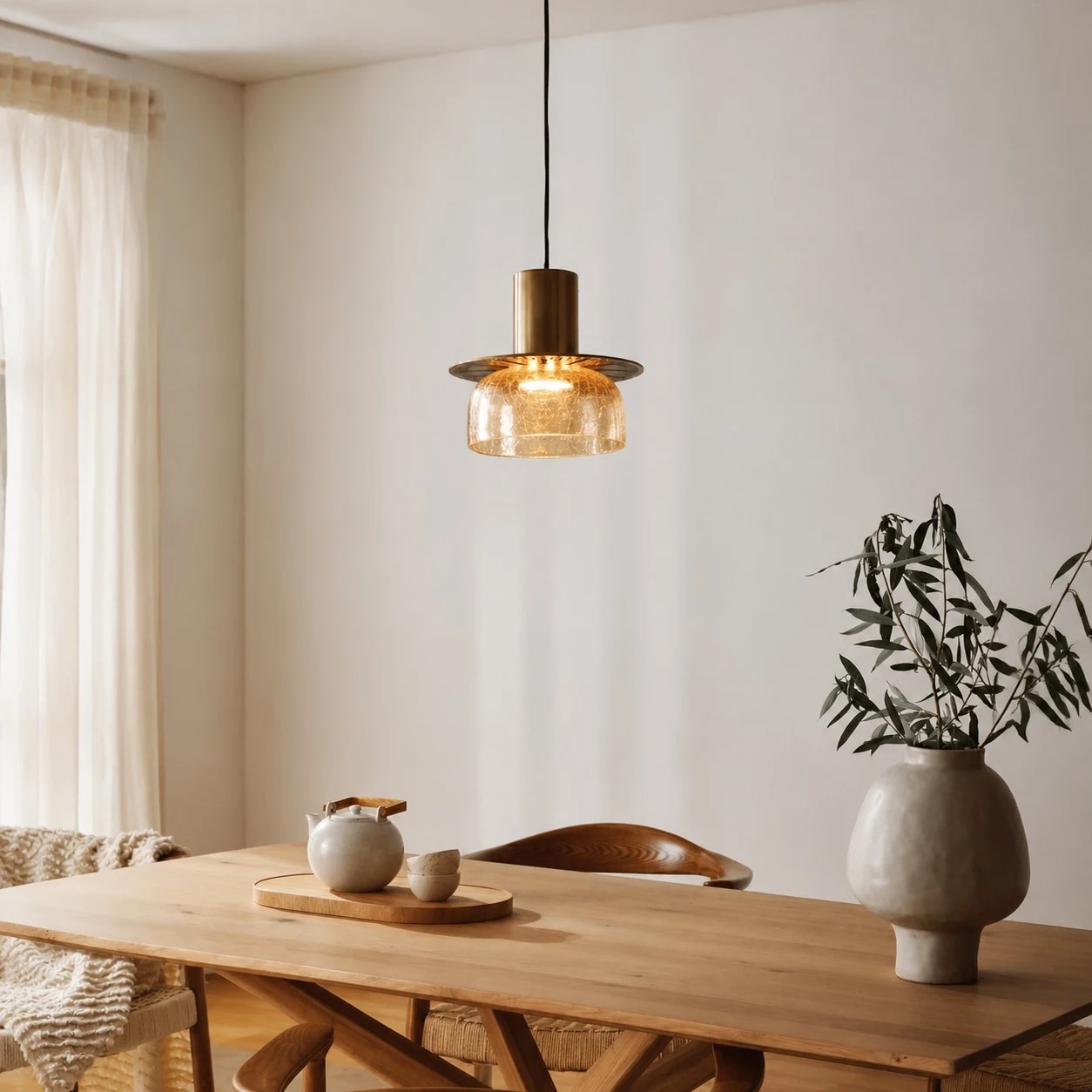 Amber brass glass pendant installed above a dining table