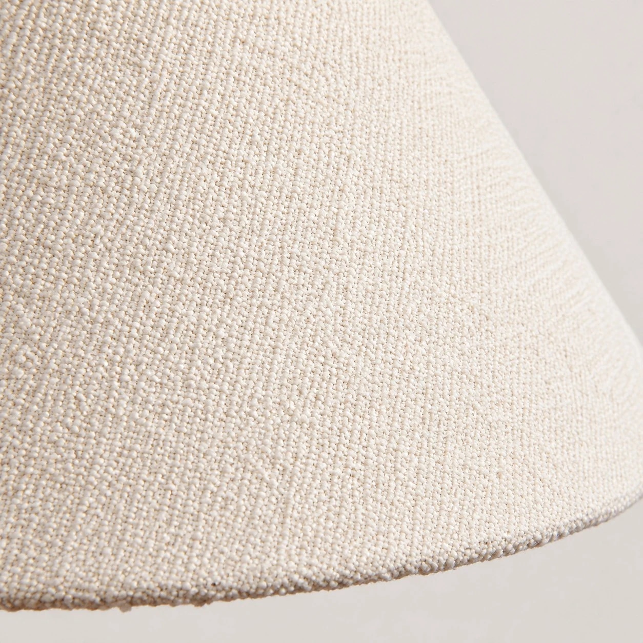 Close detail of the cream woven fabric shade texture
