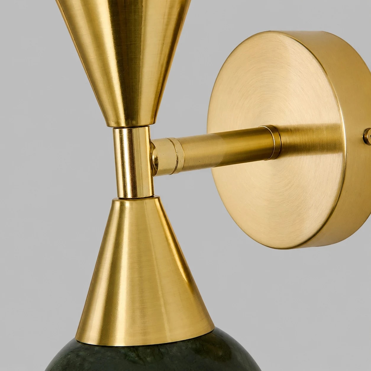 Runde Wandplatte und Lampenarmdetails aus gebürstetem Gold