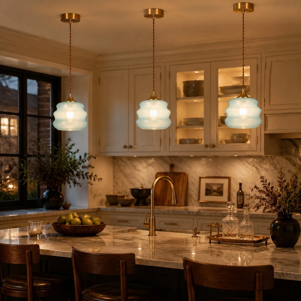 Three blue glass pendant lights above a kitchen island