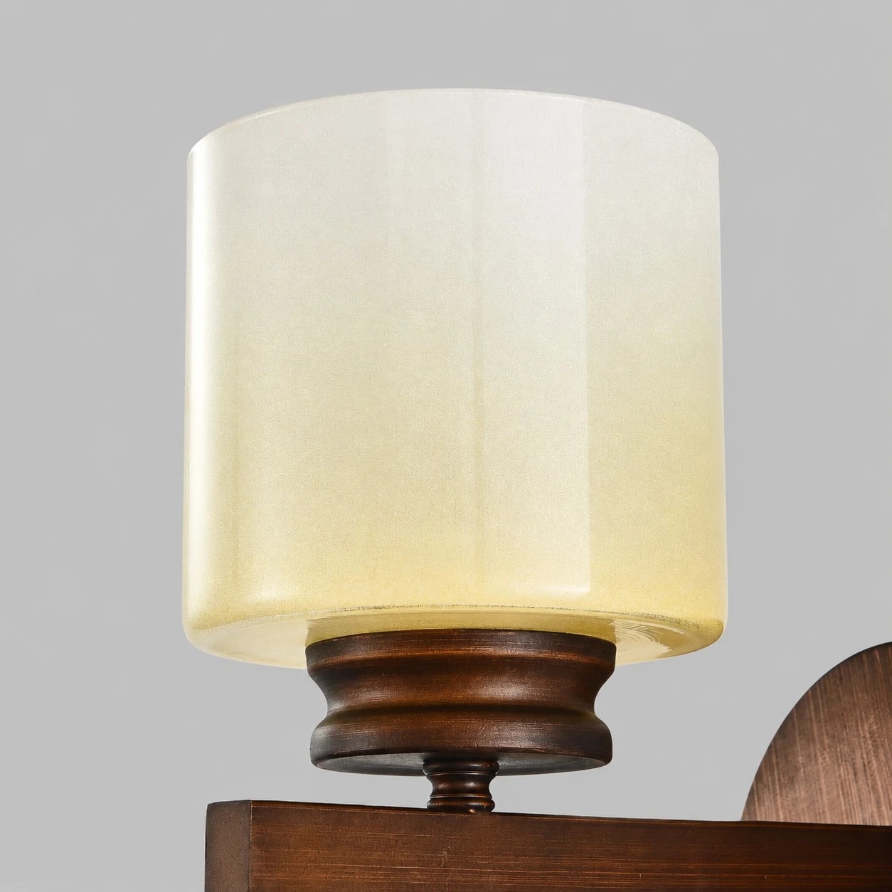 Close-up of the alabaster-style frosted glass shade on the wall sconce