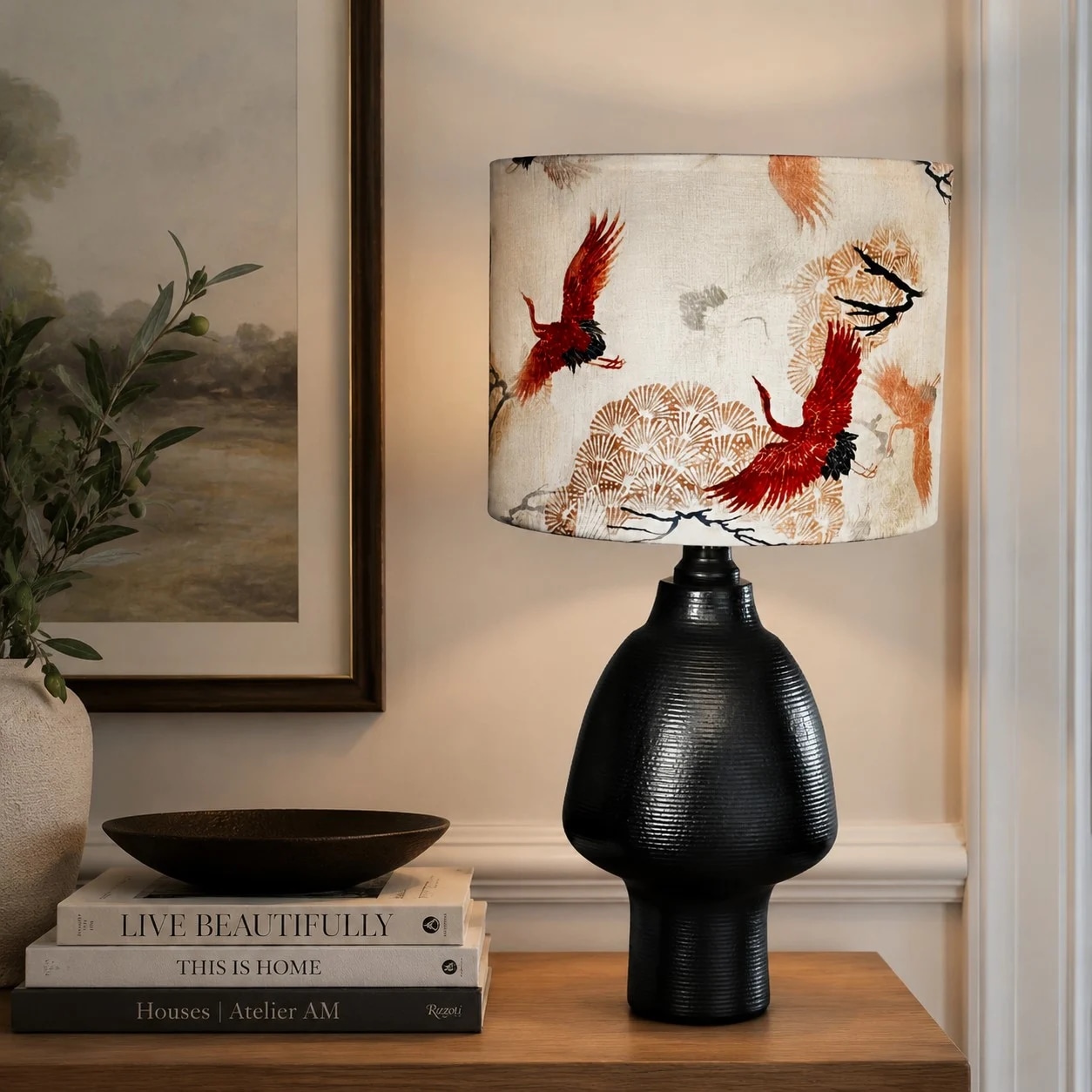Crane table lamp glowing on a console in a refined living space