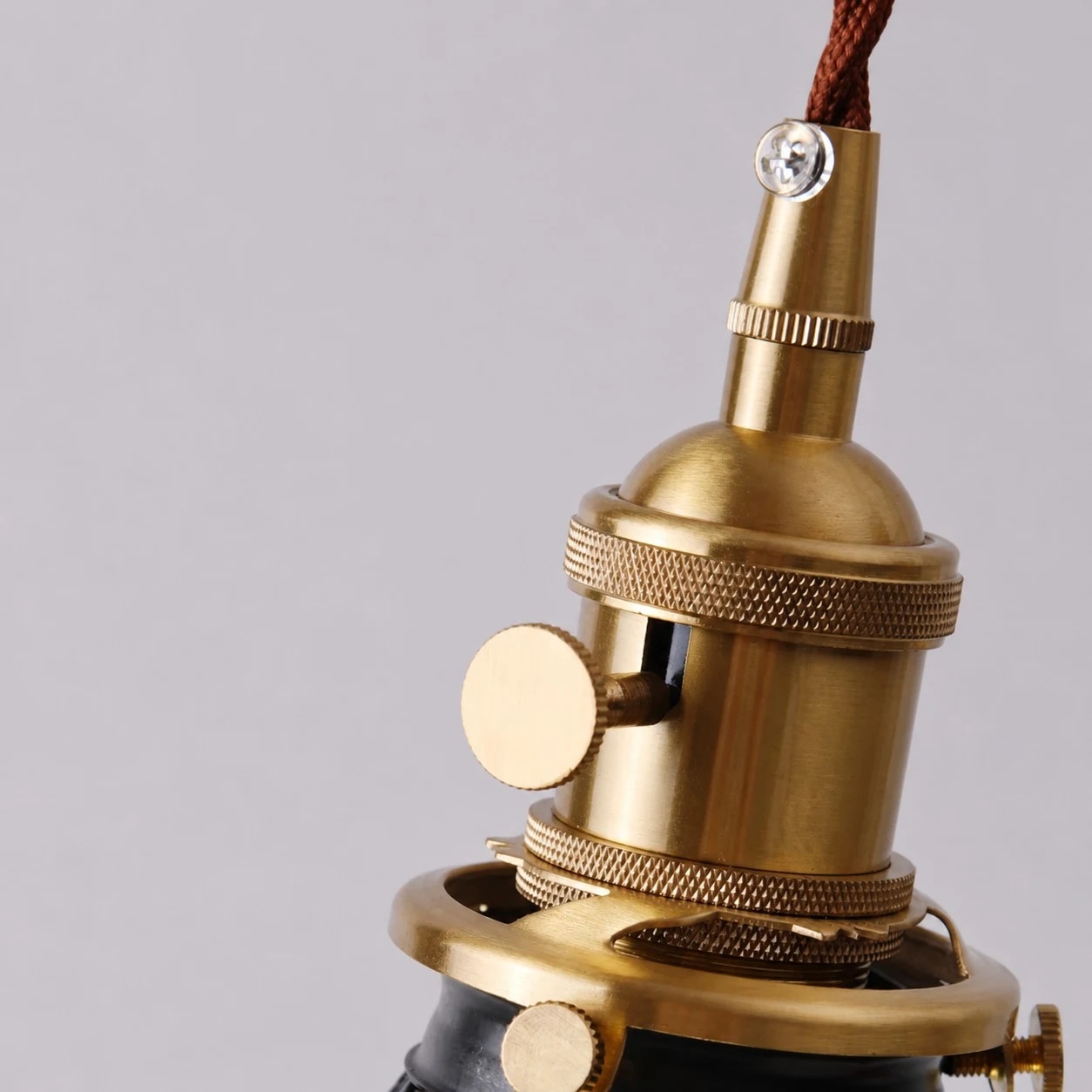 Brass toned socket and knurled hardware close-up