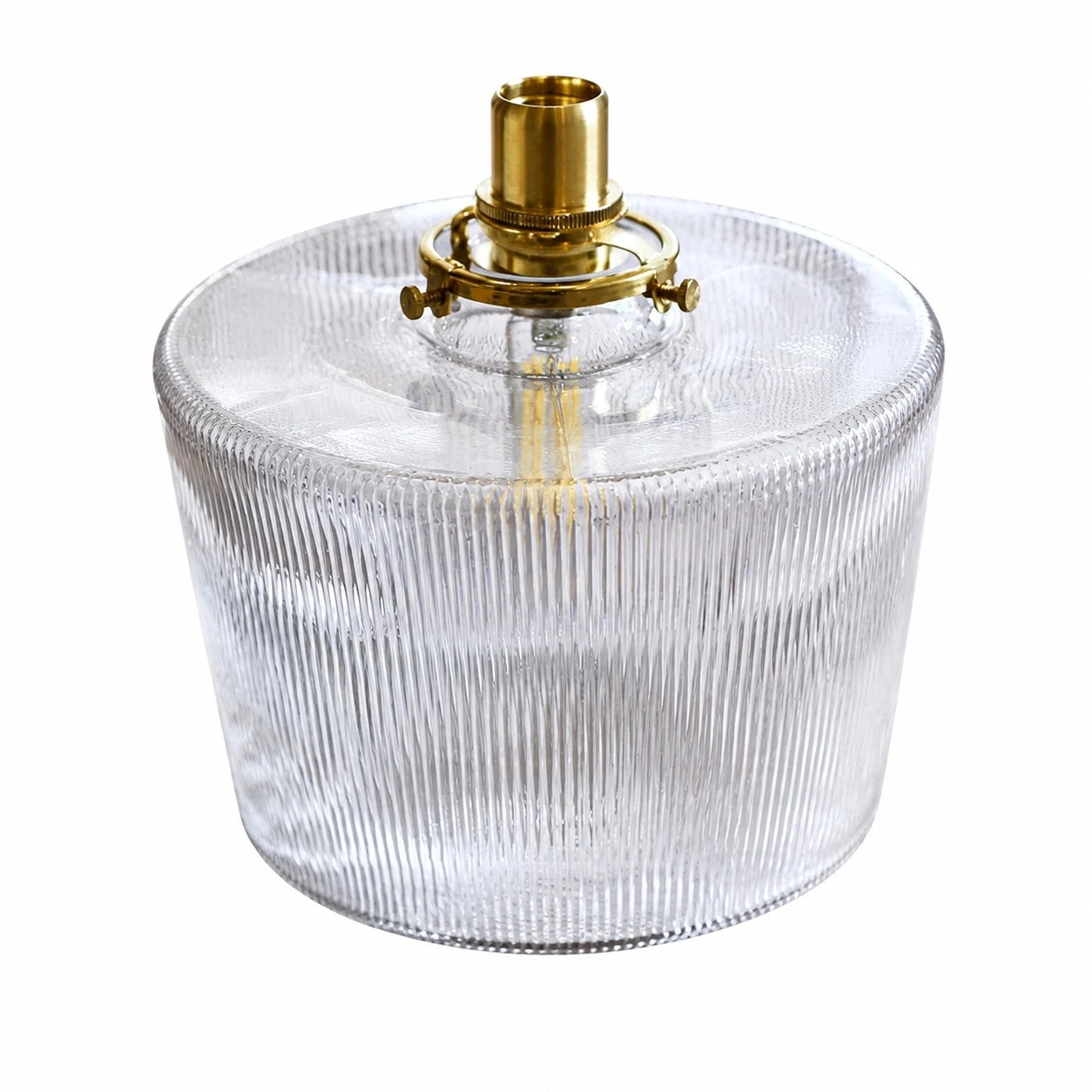 Clear ribbed glass and brass cap close-up