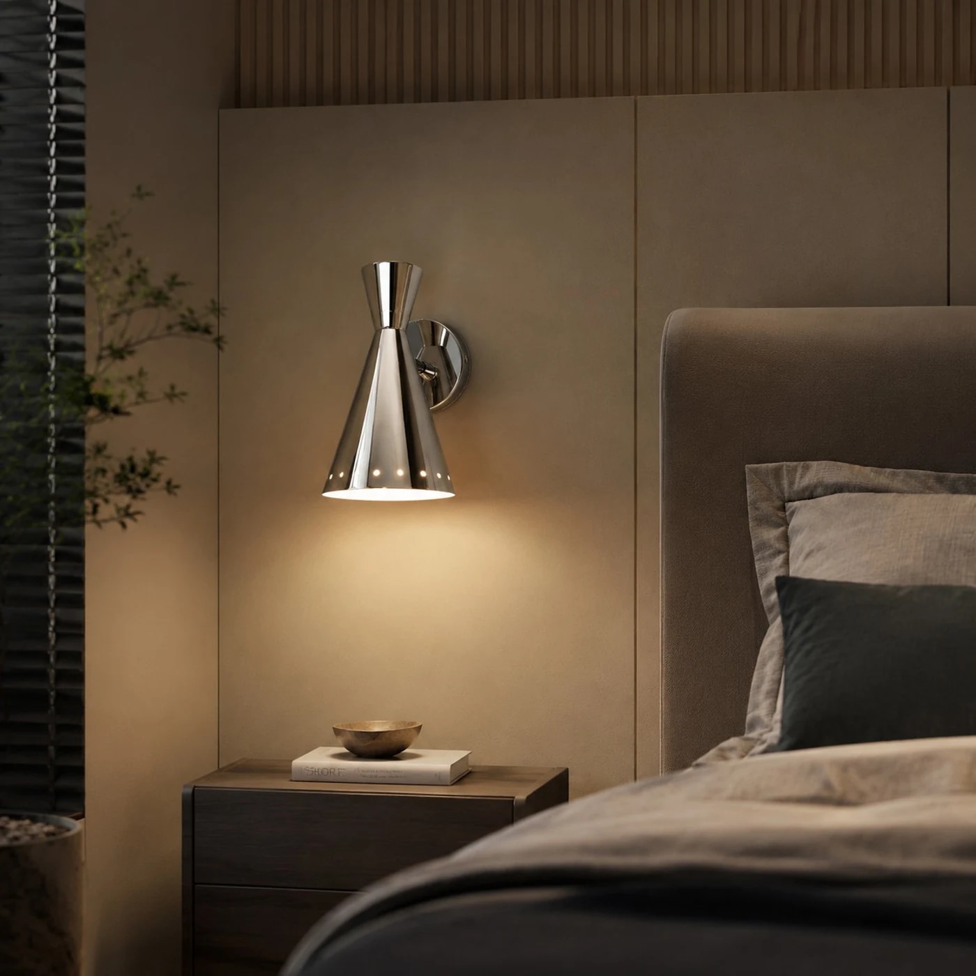 Polished Bauhaus wall sconce installed beside a bed