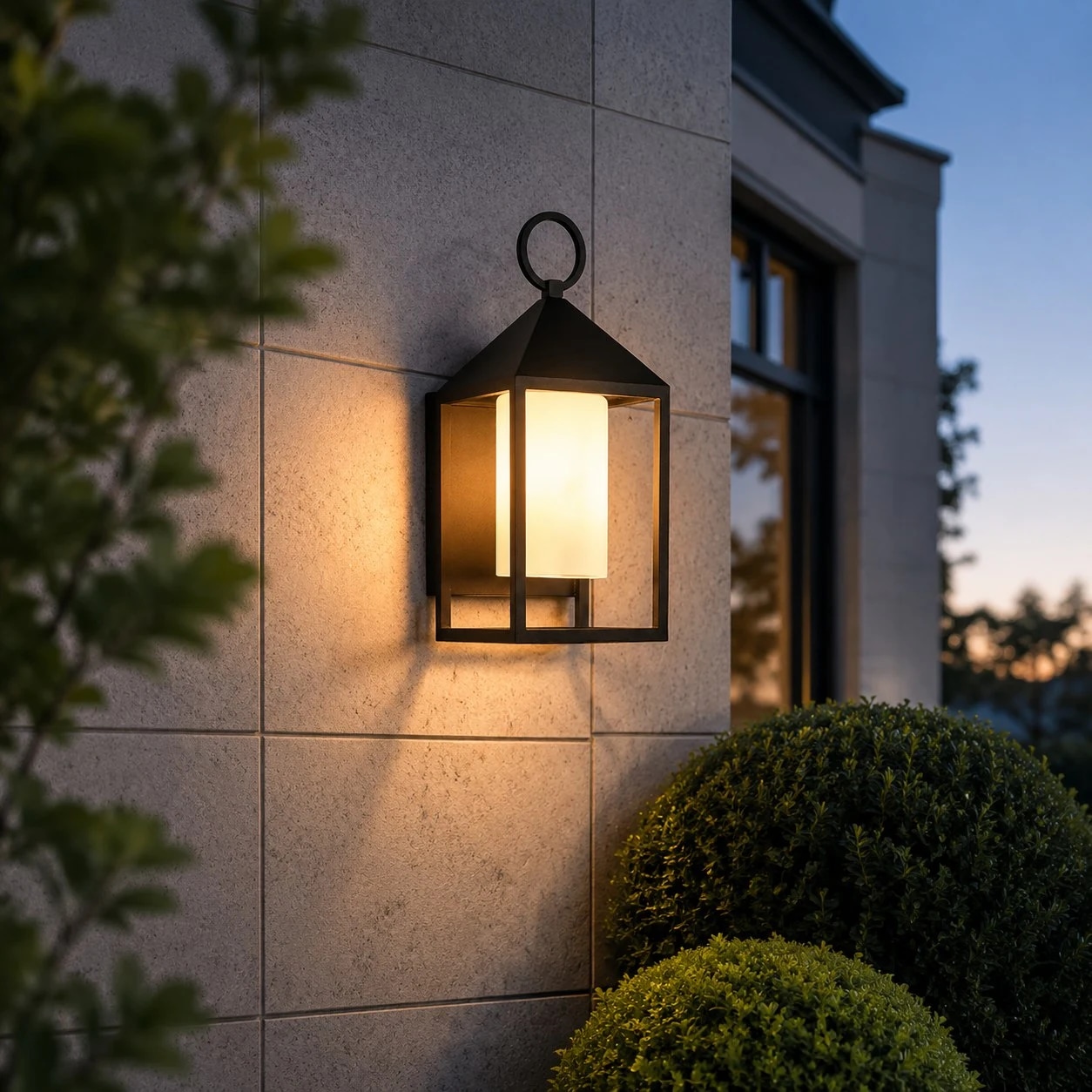 Allora black outdoor wall lamp mounted on an exterior wall with warm illumination