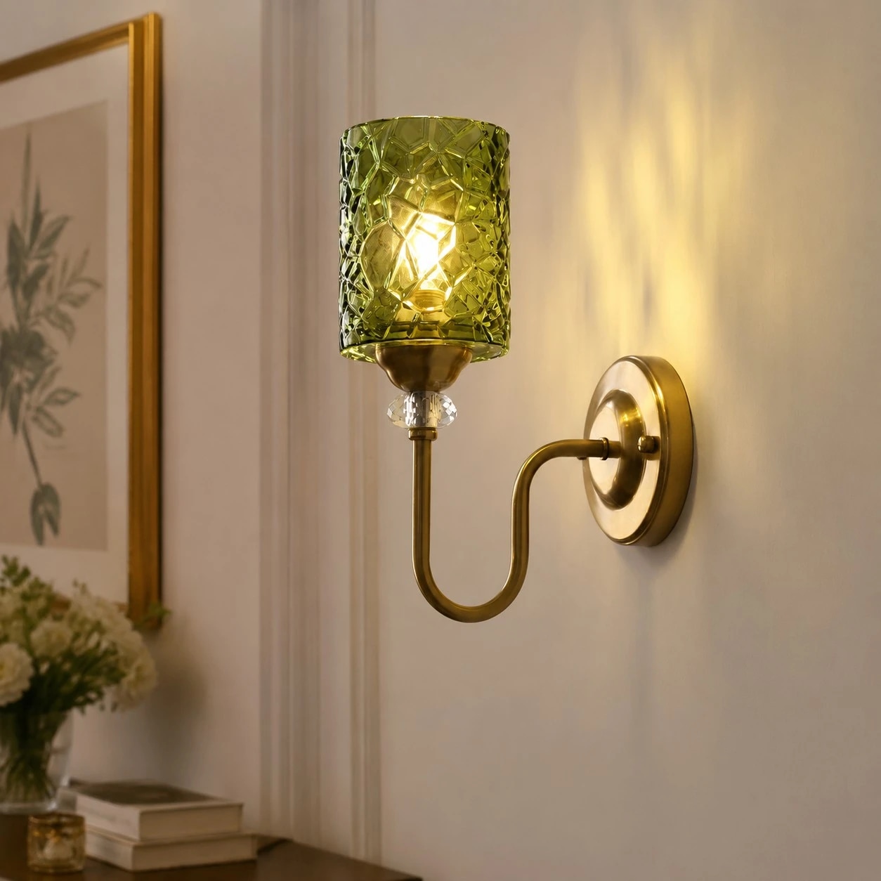Installed green glass wall sconce casting warm light on a bedroom wall