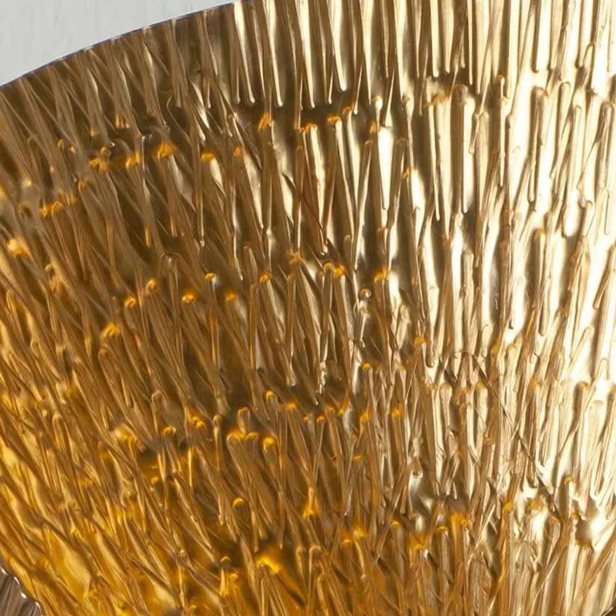 Close-up of rippled gold metal wall sconce texture