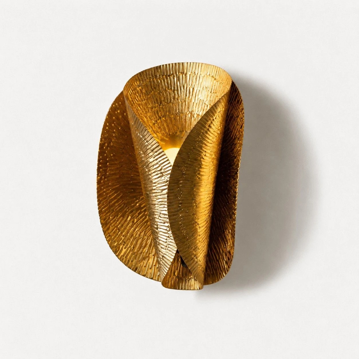 Front view of gold layered wall sconce