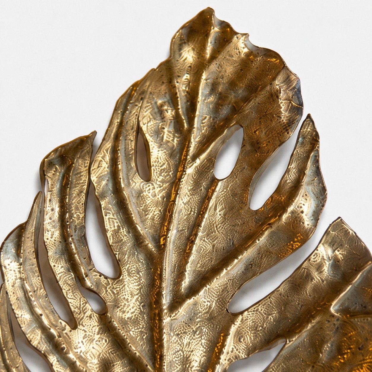 Close-up of hammered antique-gold leaf texture