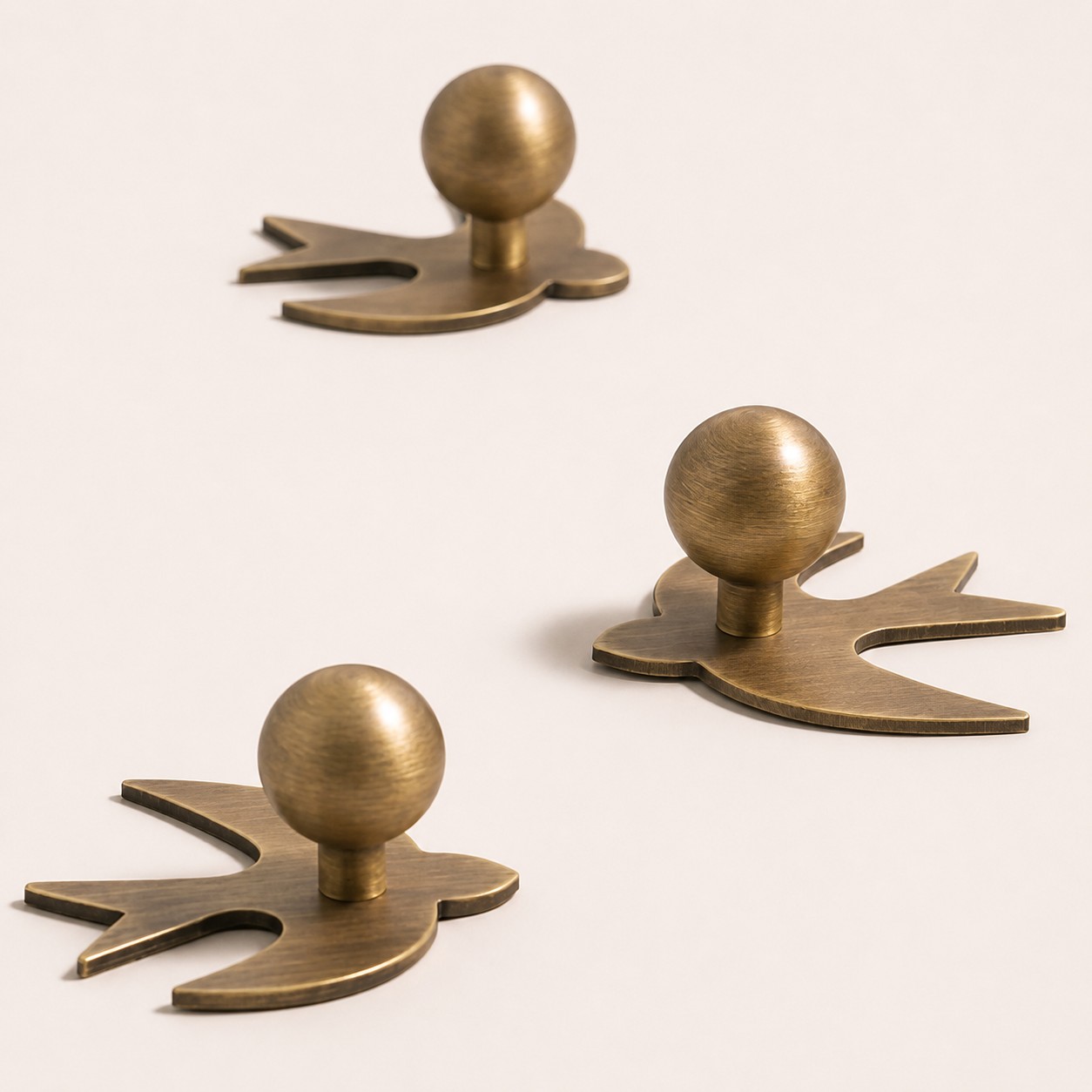 Antique brass swallow cabinet knob with rounded grip