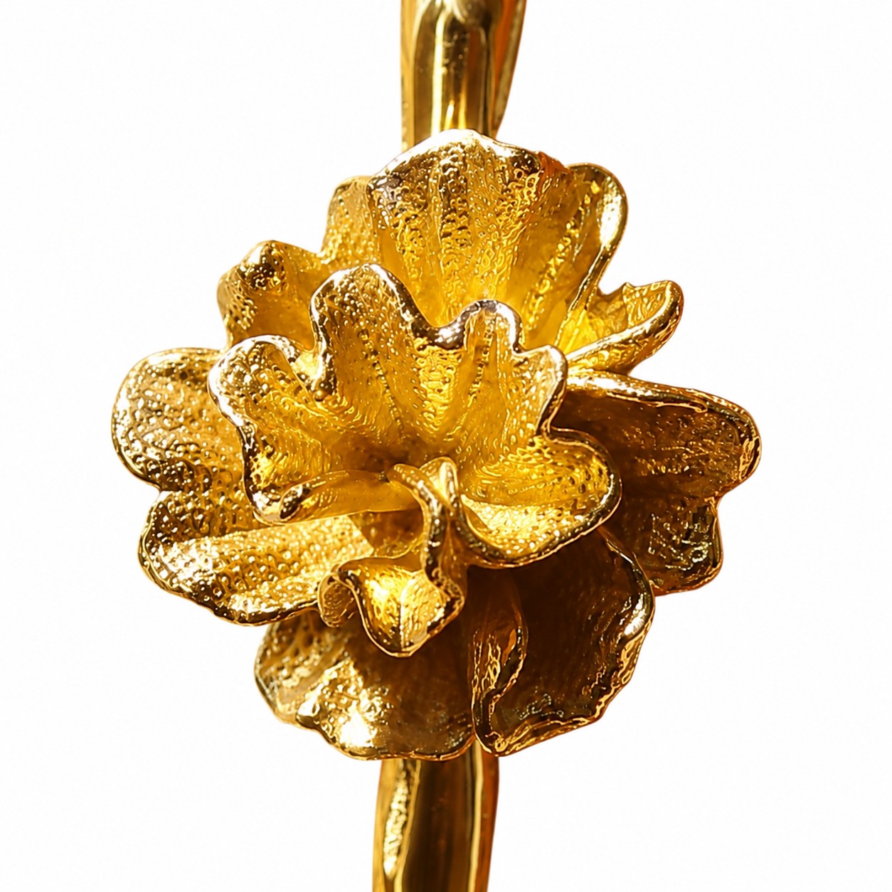 Close view of a sculpted brass flower with layered petals