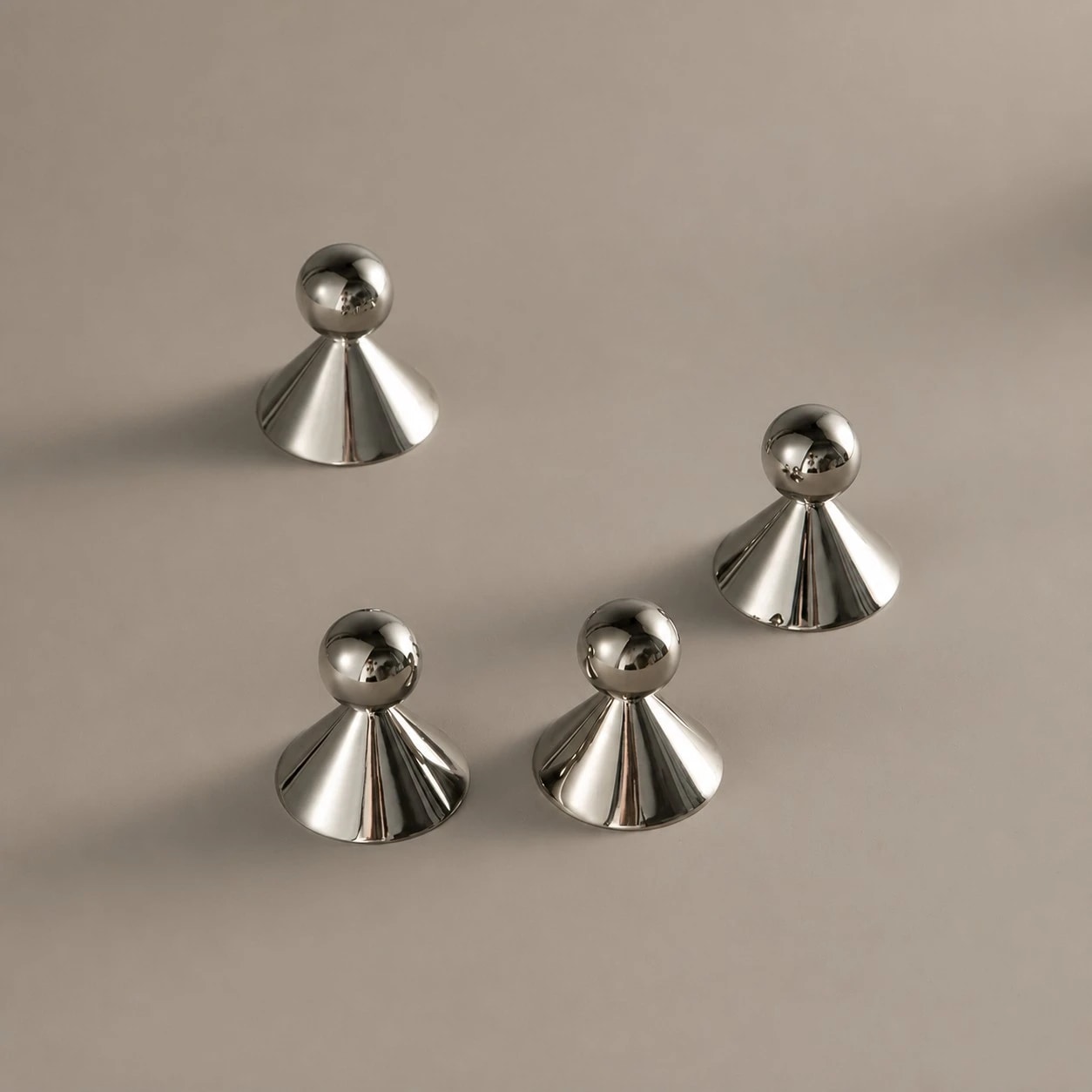 Polished silver-tone surface of the brass cabinet knobs