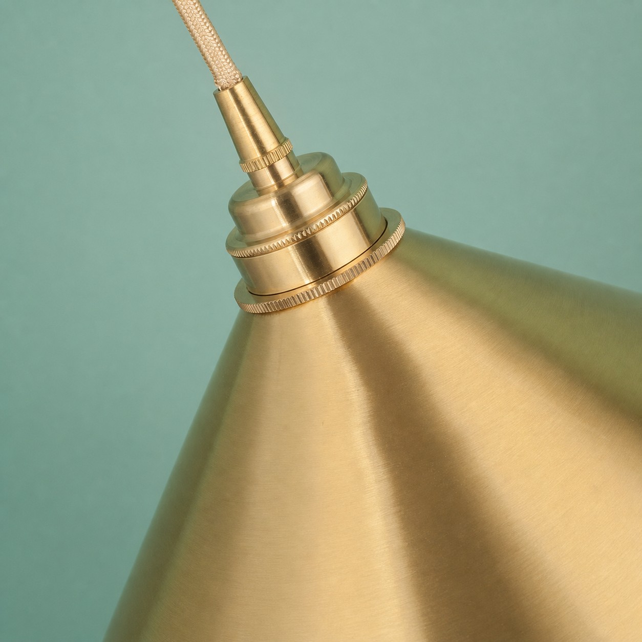 Tapered brass shade surface and upper fitting detail