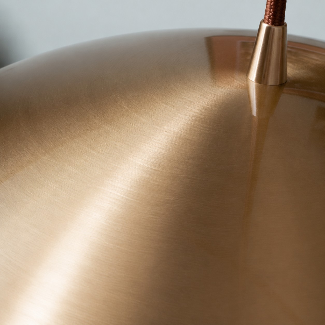Fine brushed texture on the copper shade with brushed brass finish