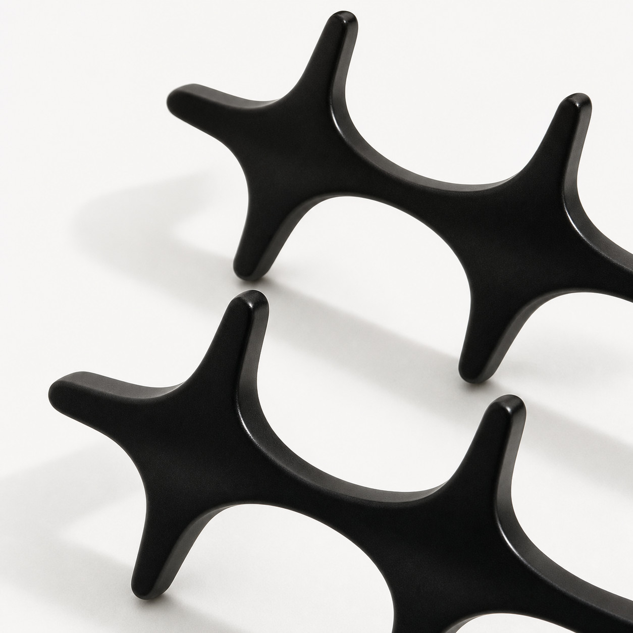 Rounded edge detail of black metal starburst cabinet pull