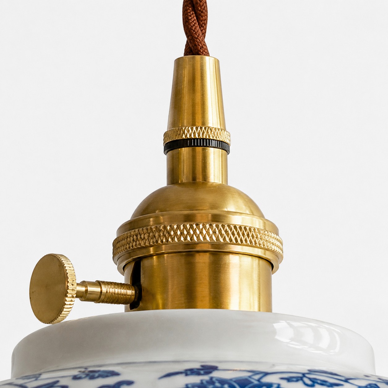 Close-up of the ceramic shade and brass-toned top hardware