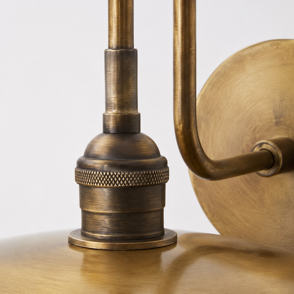 Close view of the softly aged antique brass shade surface