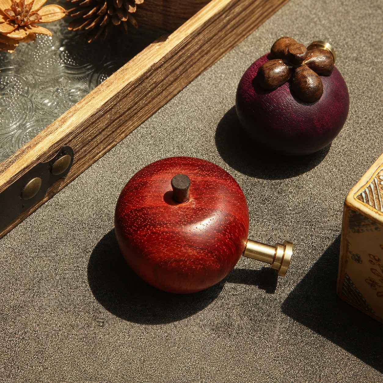 Close-up of carved wooden smiling apple cabinet hardware